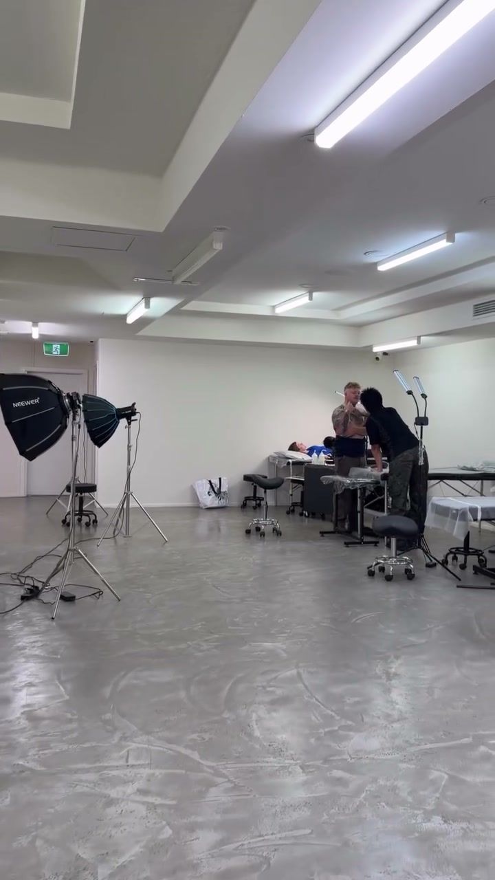 The studio floor: white walls, tattoo stations and a photo light, on the Lower Ground